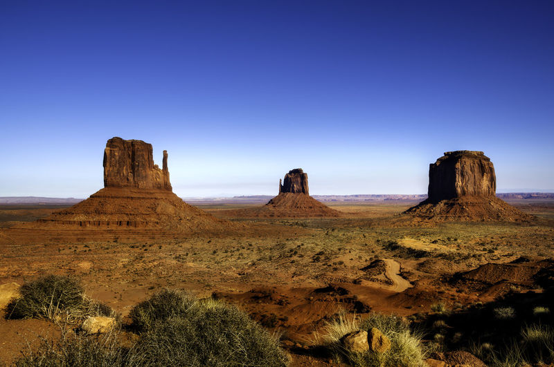 View of rock formations on landscape against blue sky