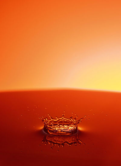 Close-up of water splashing on orange surface