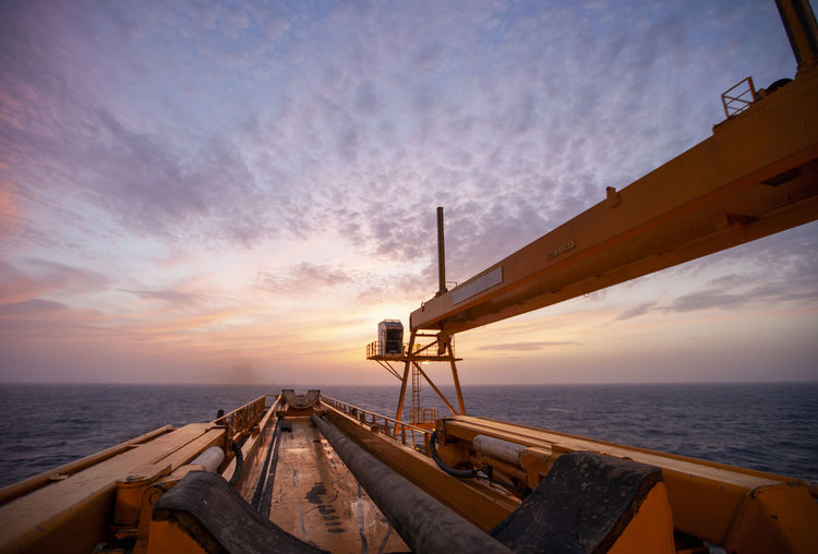 Offshore drilling during sunset in the gulf of mexico