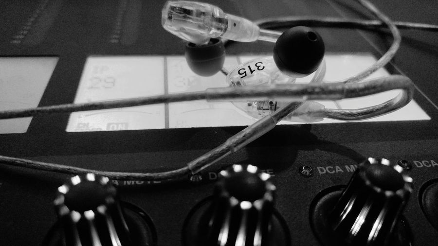 Close-up of in-ear headphones on audio equipment