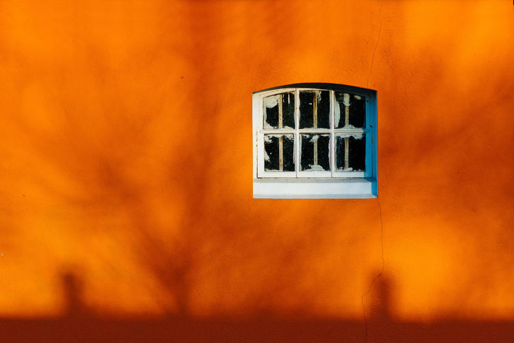 Close-up of  window in orange wall