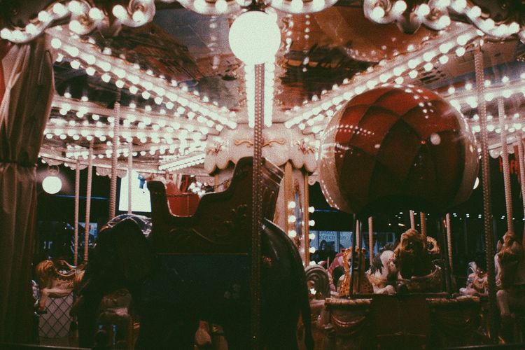 Illuminated carousel at night