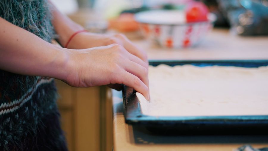 Close-up of woman hand with pastry dough