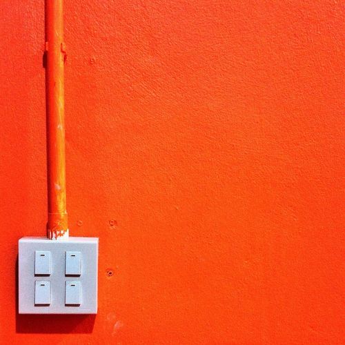 Light switch on orange wall
