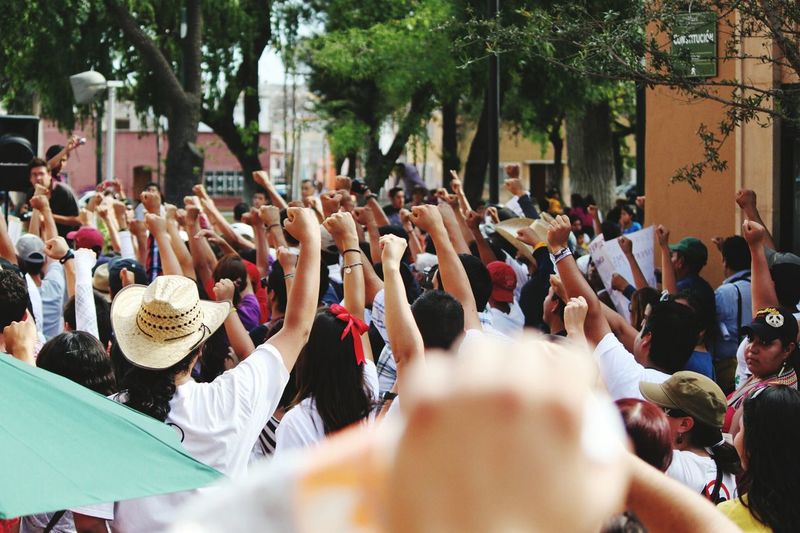 Protestors with arms raised standing