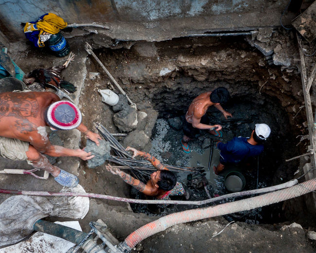 High angle view of men working on rock