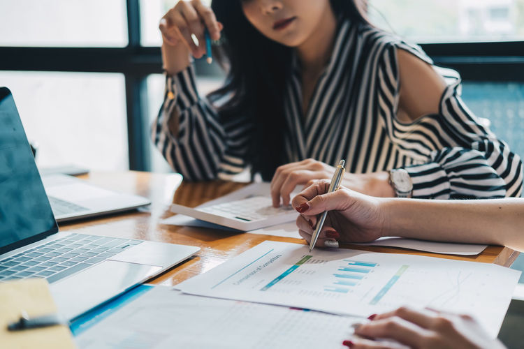 Midsection of businesswoman working at office