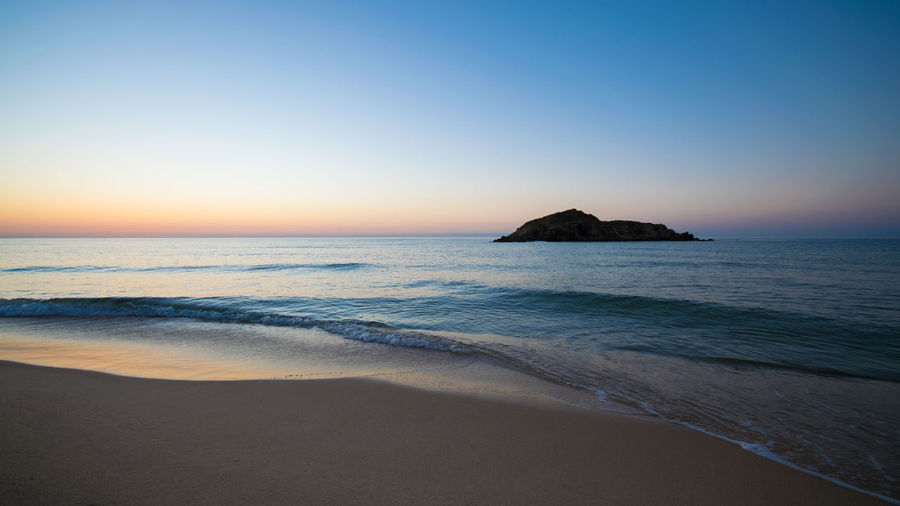 Scenic view of sea against clear sky during sunset