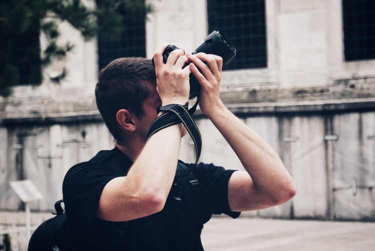 Man photographing in city