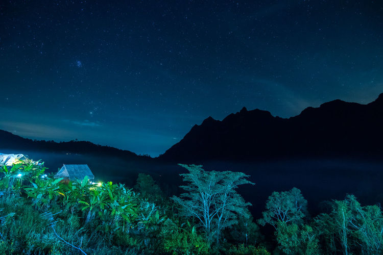 Scenic view of mountains against blue sky at night