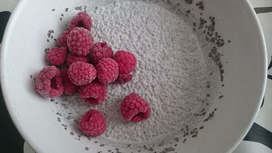 Close-up of raspberry with coconut milk and chia seeds