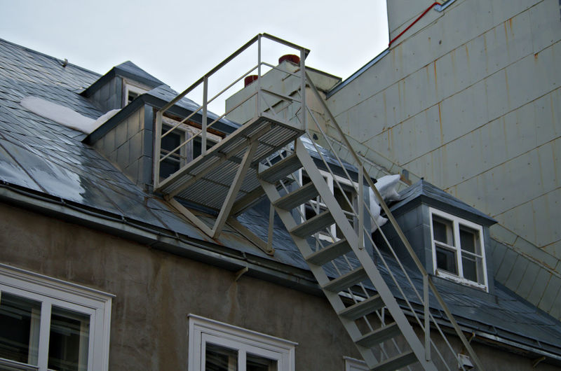 Low angle view of metal staircase on building