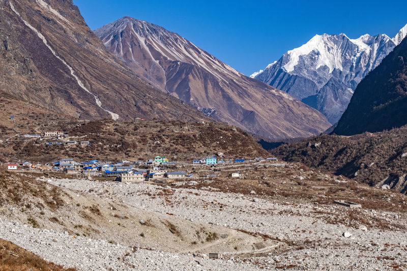 Scenic view of snowcapped mountains against clear blue sky
