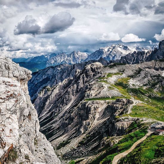Scenic view of mountains against cloudy sky