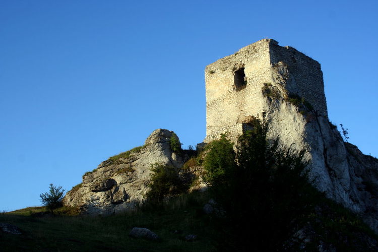 Low angle view of castle against clear blue sky