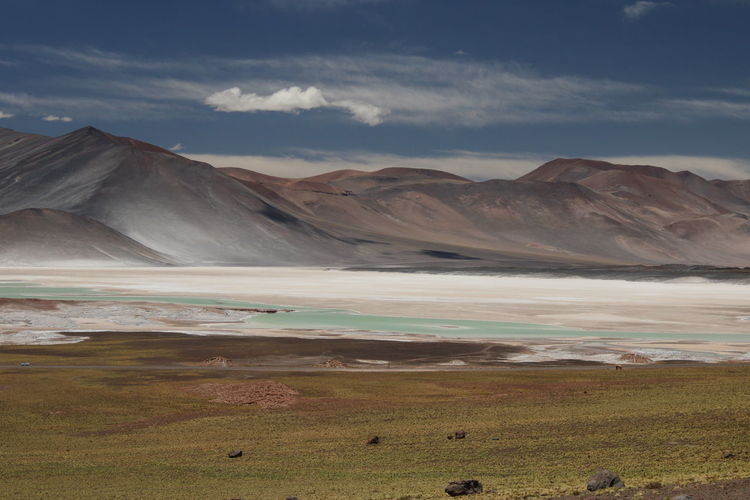 Red mountains and blue salty lagoon at piedras rojas, atacama desert, chile