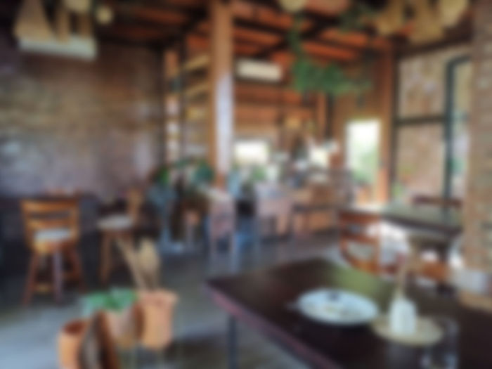 Defocused image of chairs and table in restaurant