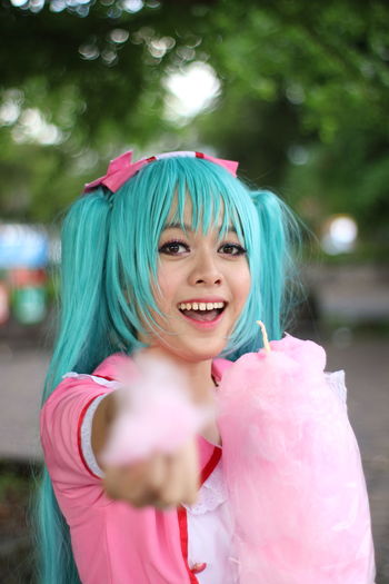 Portrait of beautiful young woman with cotton candy