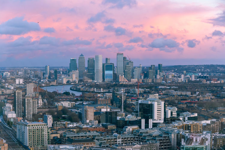 Aerial sunset cityscape of london and the river thames with canary wharf in the background