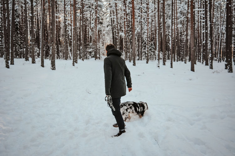 Man with dog in snow