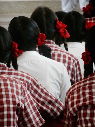 Rear view of schoolgirls in classroom