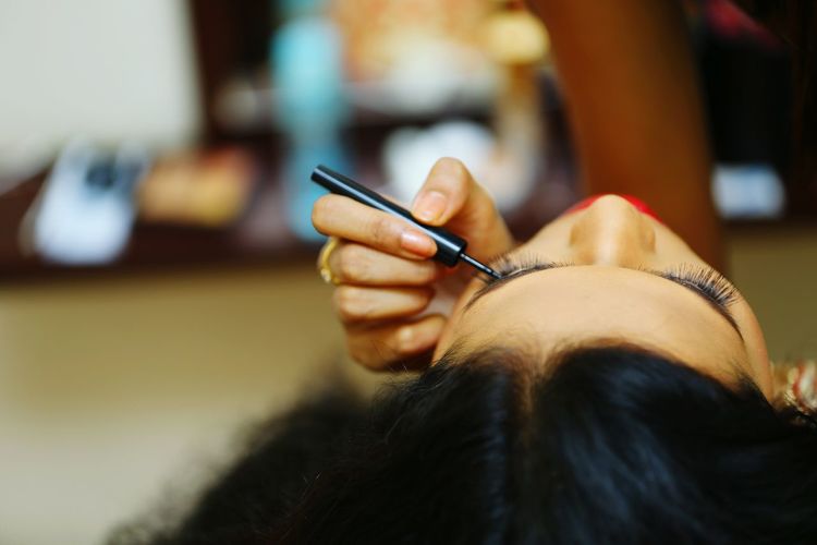 Close-up of woman applying mascara