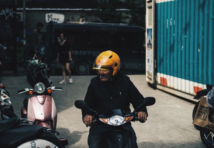 Man riding motor scooter