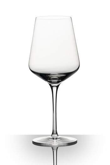 Close-up of wineglass against white background