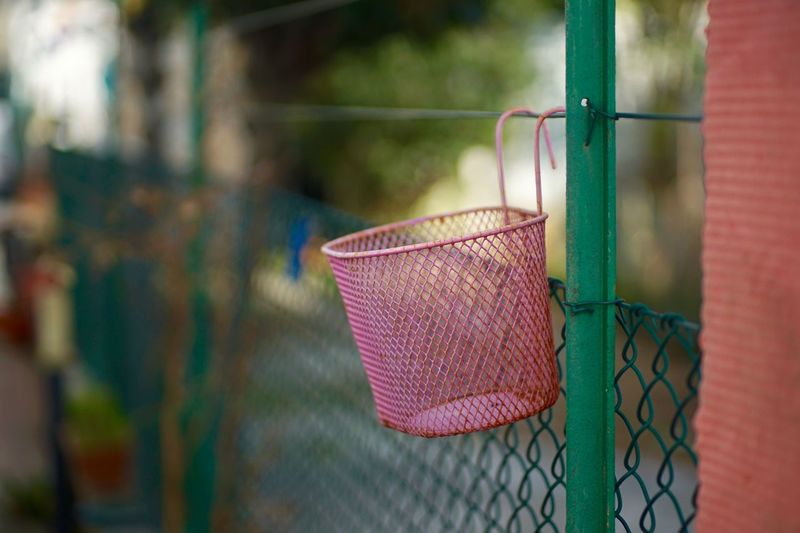 Basket hanging on fence
