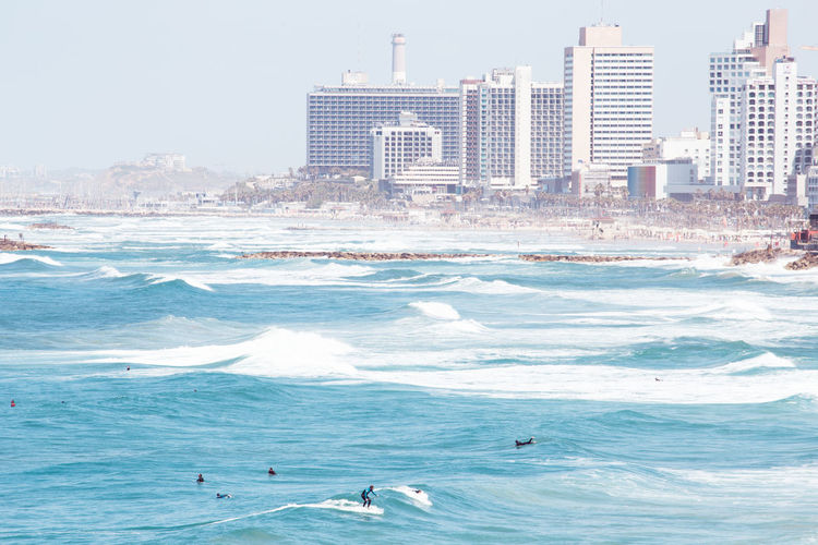 Scenic view of sea and buildings against sky