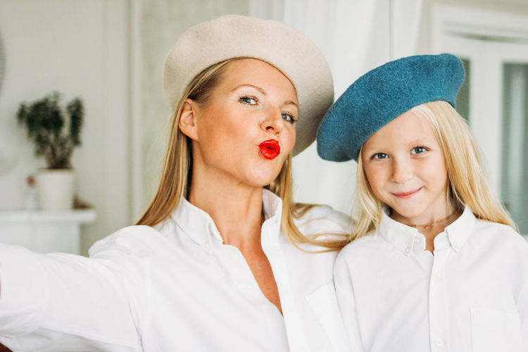 Portrait of smiling mother and daughter at home