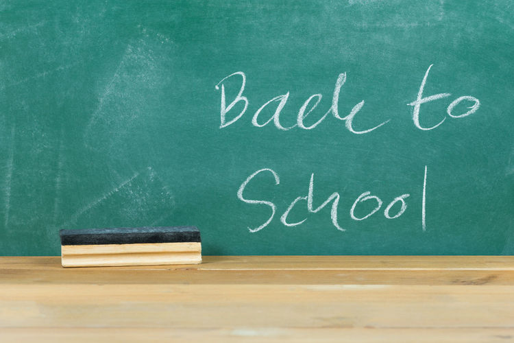 Back to school text on blackboard in classroom