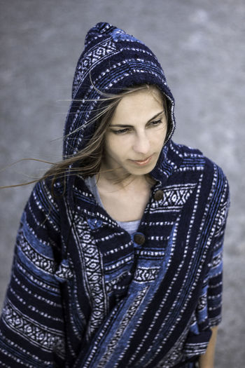 High angle view of young woman wearing hooded clothing outdoors
