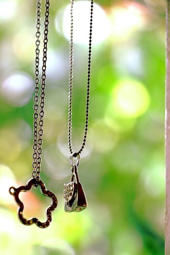 Close-up of chains with pendants against blurred background