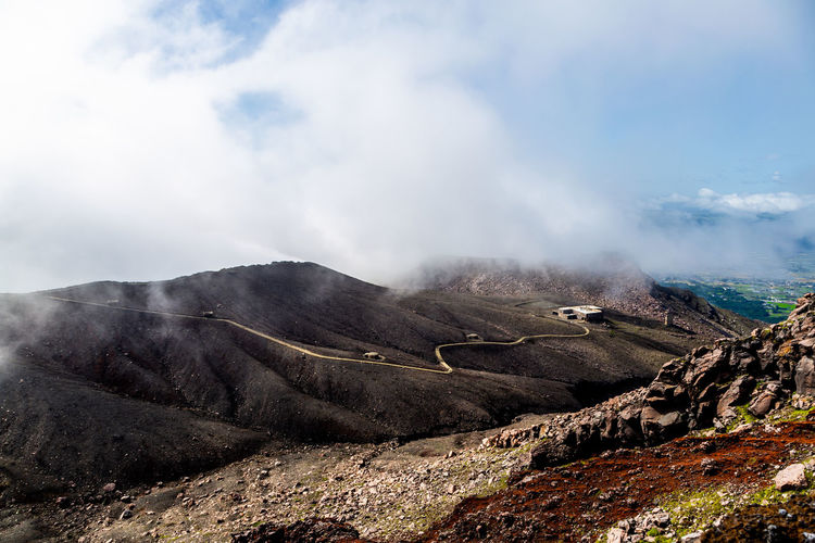 Panoramic view of volcanic landscape, abandoned cable car against sky