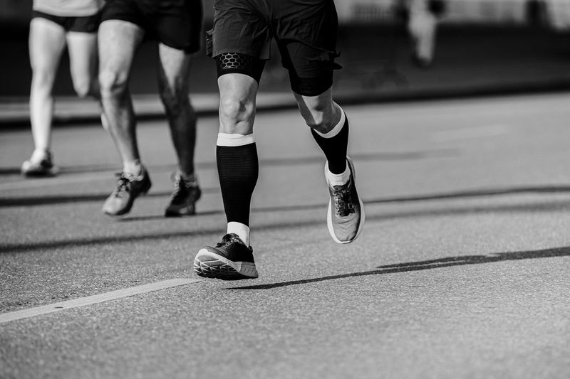 Low section of people running on road