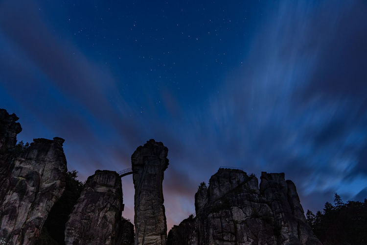 Low angle view of mystical rocks against sky at night