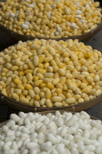 High angle view of silkworms cocoons for sale in baskets
