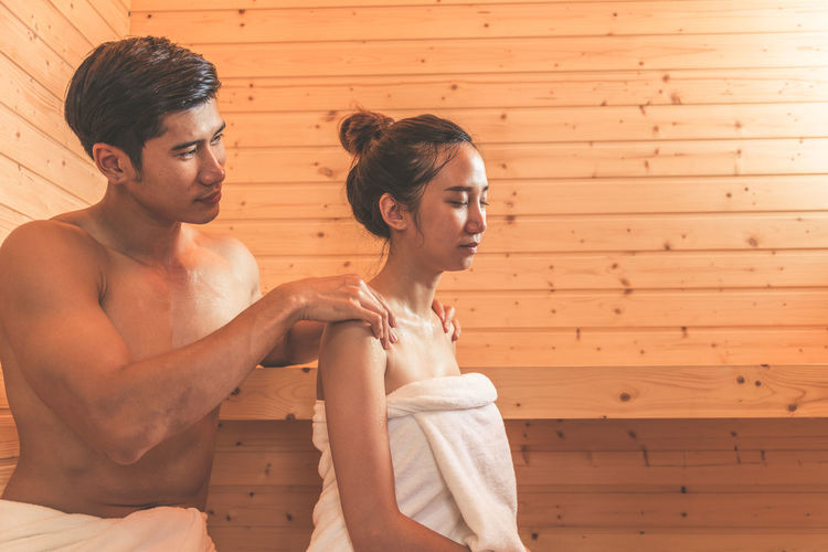 Young couple sitting in sauna