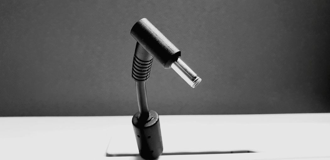 Close-up of audio jack on table against black background