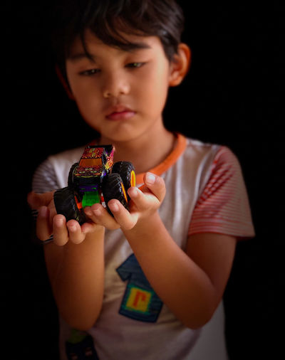 Close-up of boy looking at toy