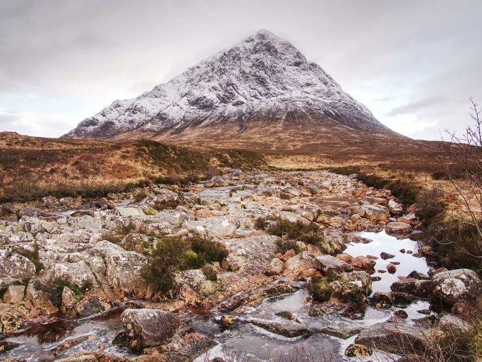 Winter trek. buachaille etive mor in glencoe, t he highlands of scotland. sunny winter day.