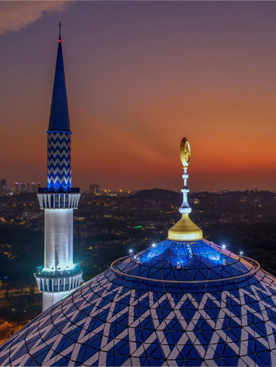 Low angle view of mosque against sky during sunset
