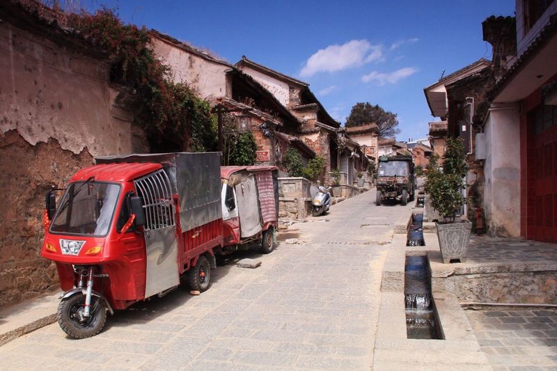 Jinrikishas parked at street on sunny day