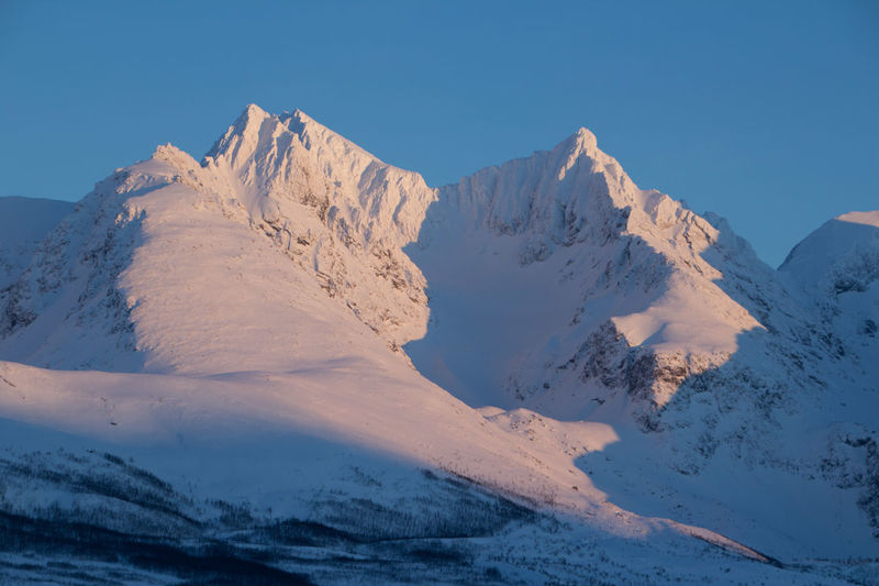 Scenic view of mountains against blue sky