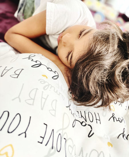 Close-up portrait of woman sleeping on bed