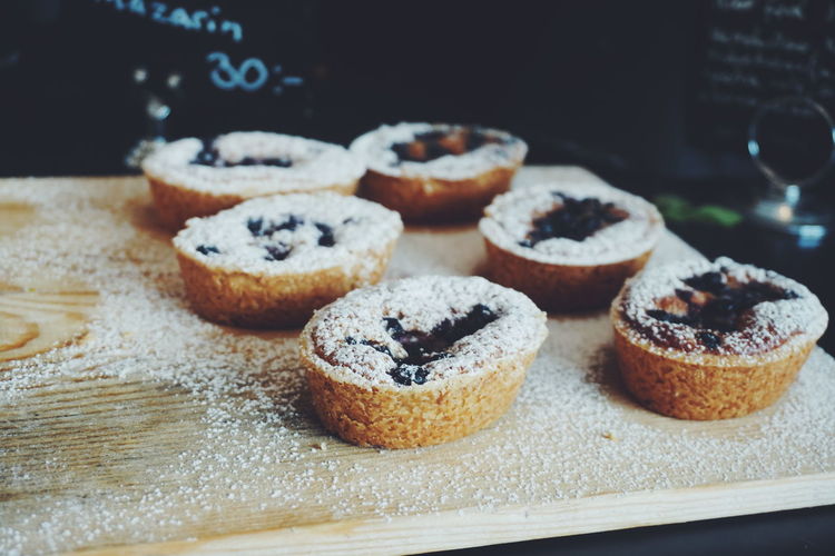 Close-up of chocolate cupcakes with powdered sugar at bakery