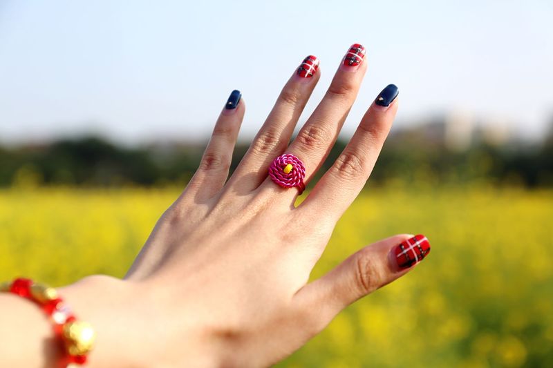 Close-up of woman hand against blurred background