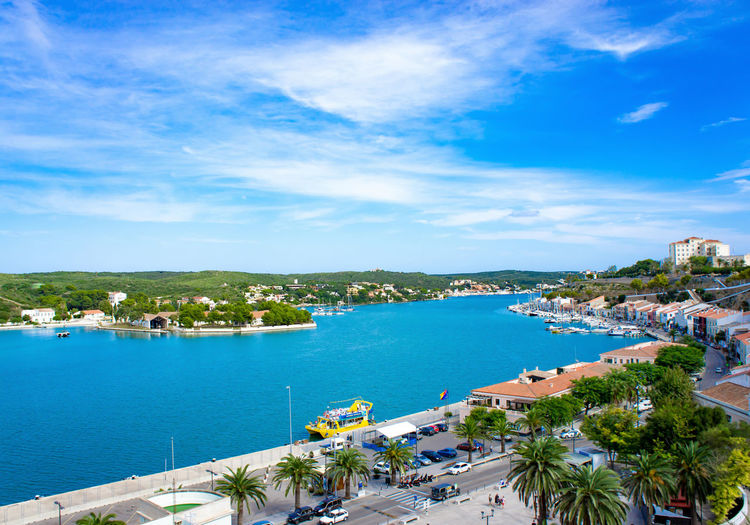 High angle view of city by sea against sky