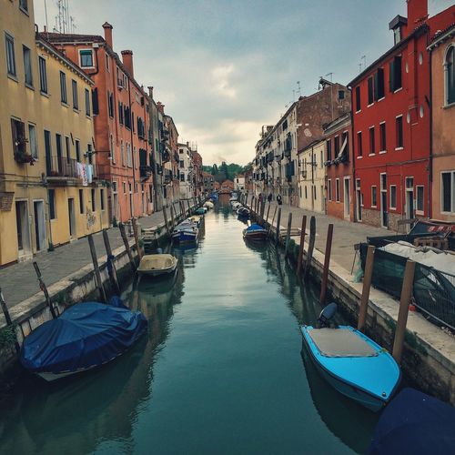 Boats in canal with buildings in background